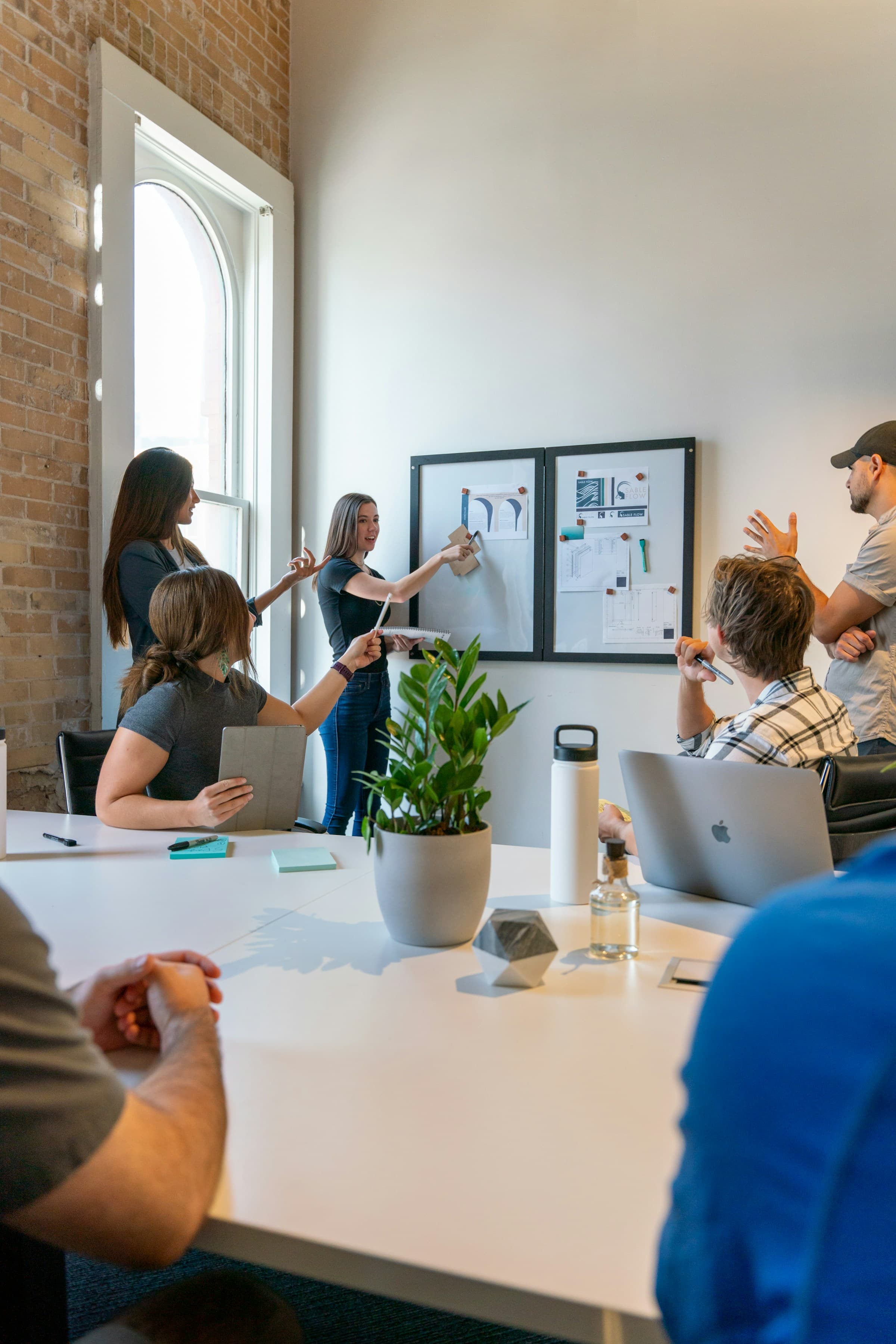 Collaborative brand strategy meeting with presentation boards